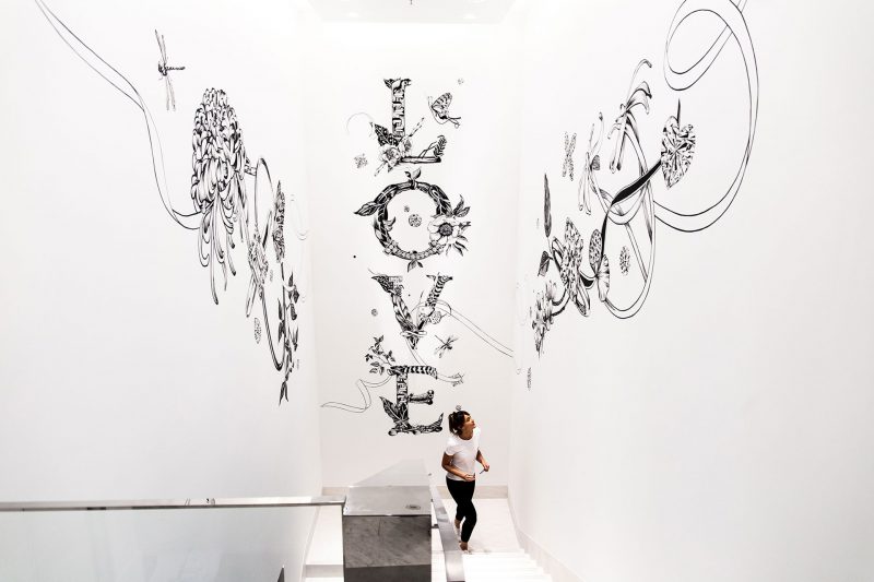 A large scale mural, featuring the word love, in a stairwell. 